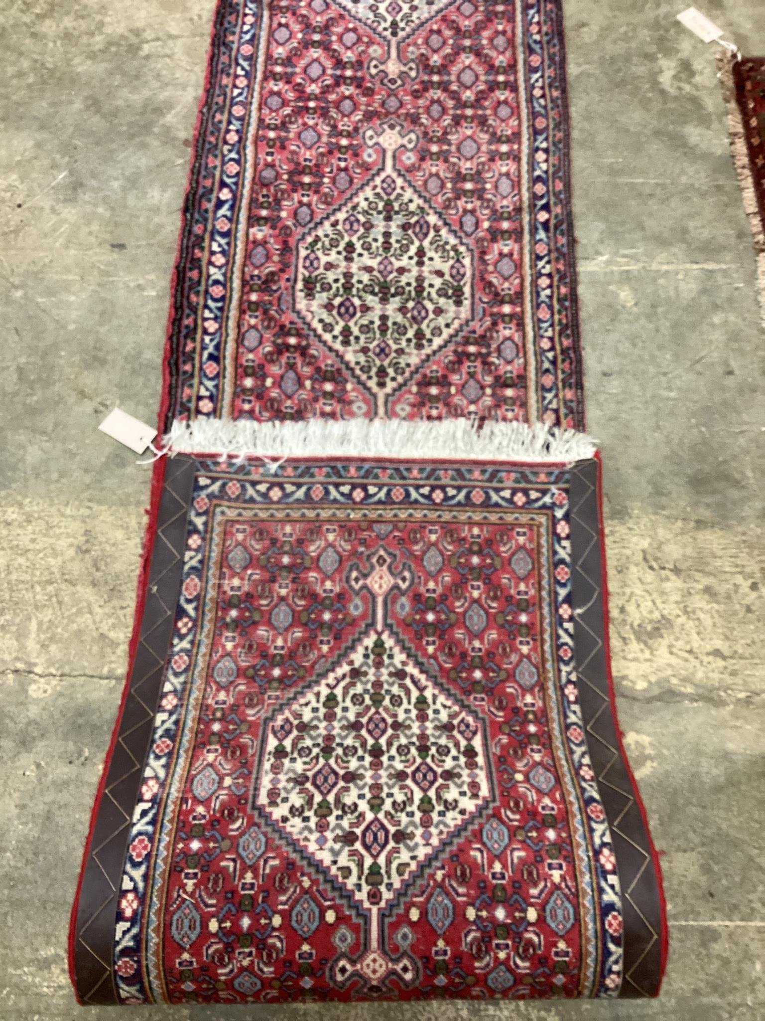 A North West Persian red ground runner, 366 x 55cm